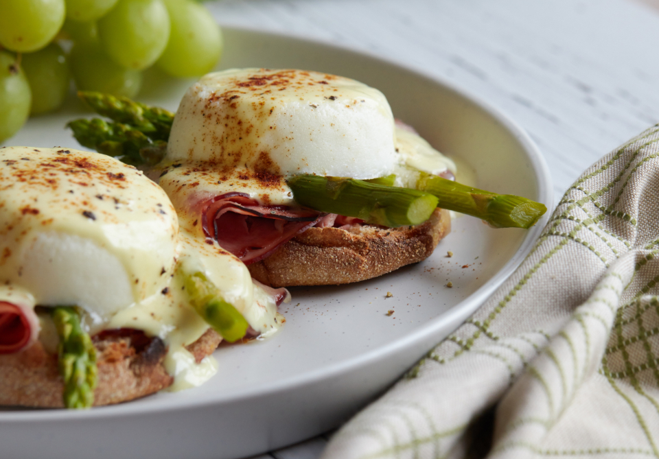 breakfast, eggs, plate, benedict, dish, food, ham, brunch, poached, muffin, hollandaise, meal, toast, bread, asparagus, vegetable, gourmet, grapes, fruit, close up, eating